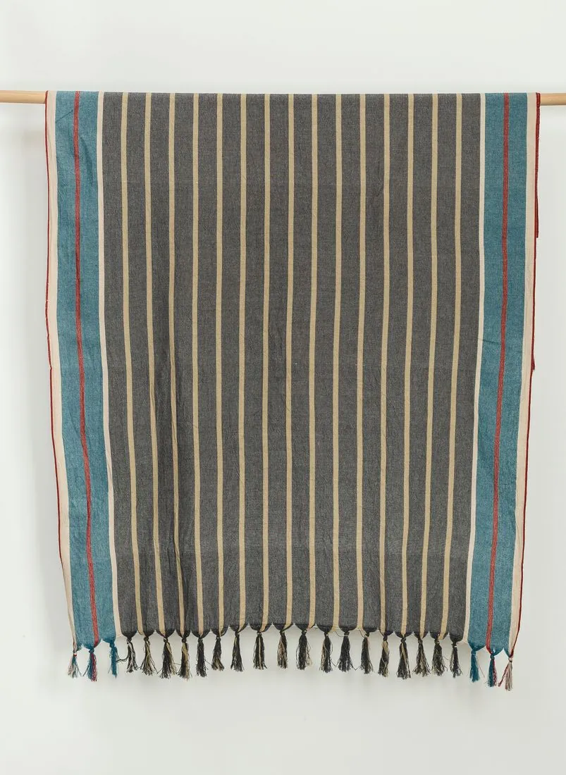 Cunda striped cotton beach towel hanging on a wooden rail