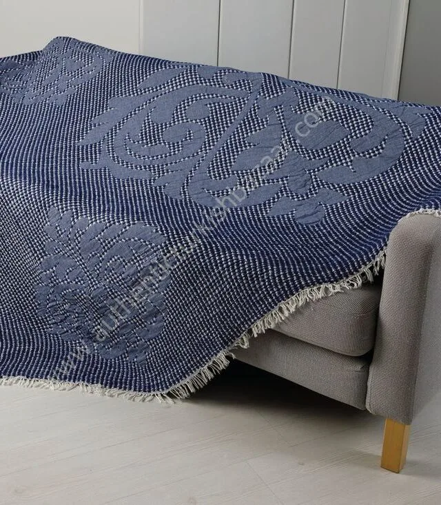 Navy waffle-weave cotton blanket over a sofa