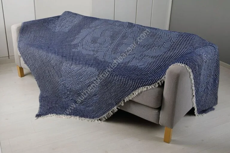 Navy waffle-weave cotton blanket over a sofa