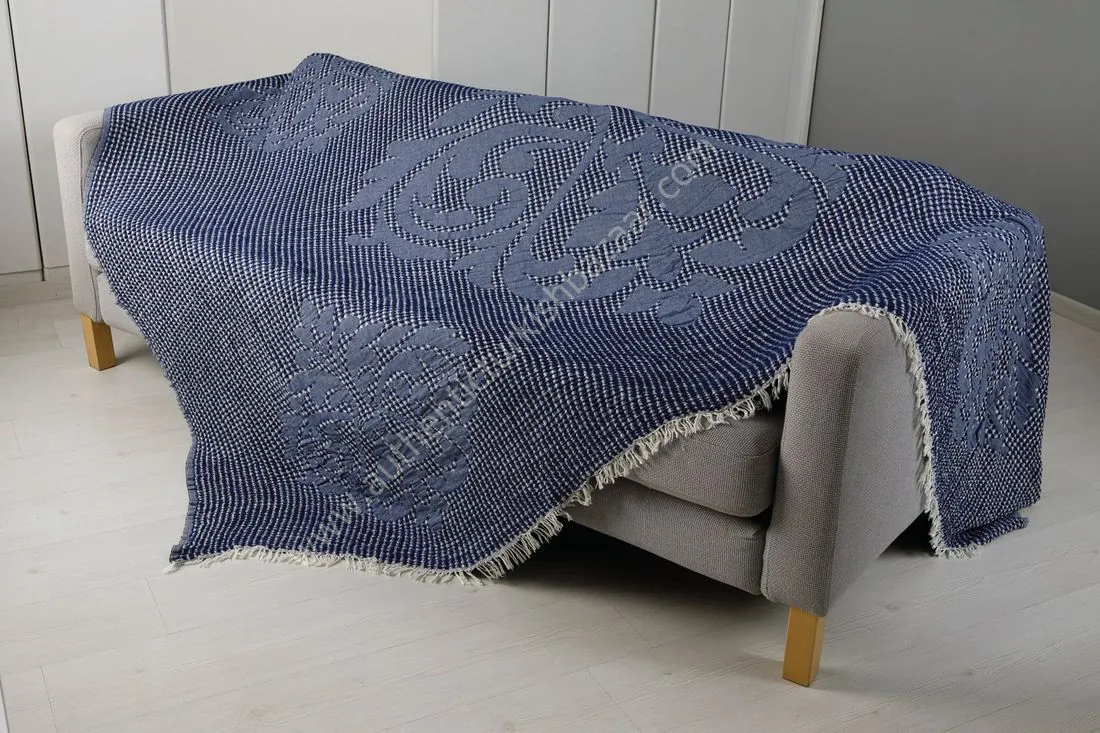 Navy waffle-weave cotton blanket over a sofa